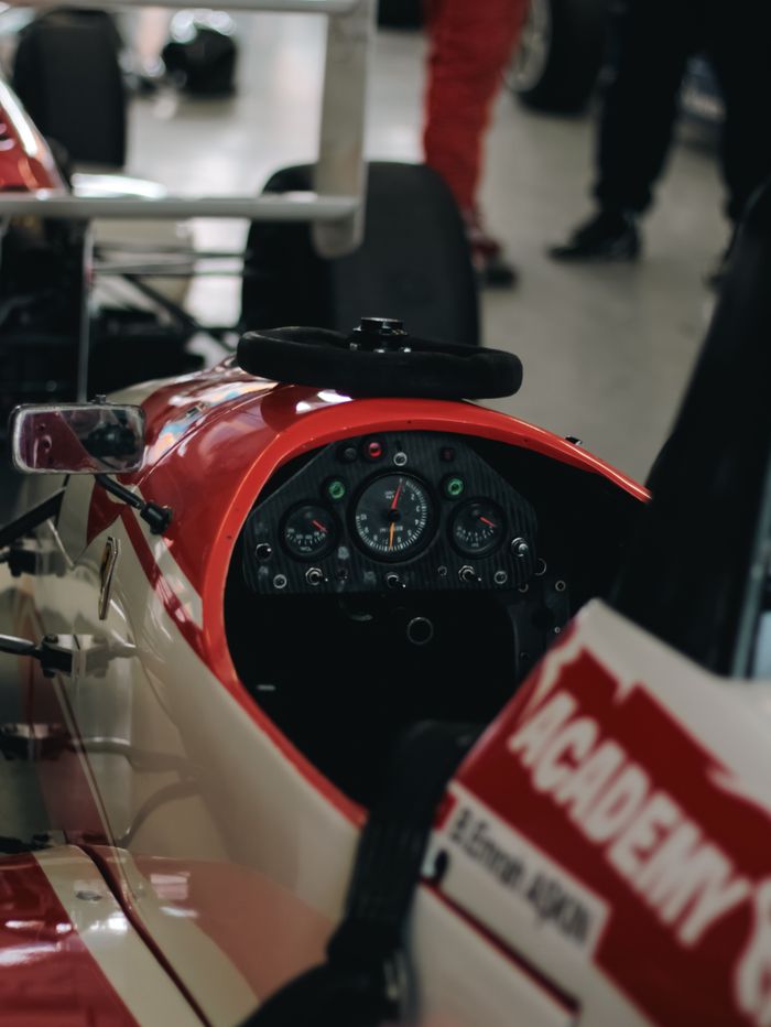 services-01 Detailed view of a Formula racing car cockpit, showcasing instruments and design.