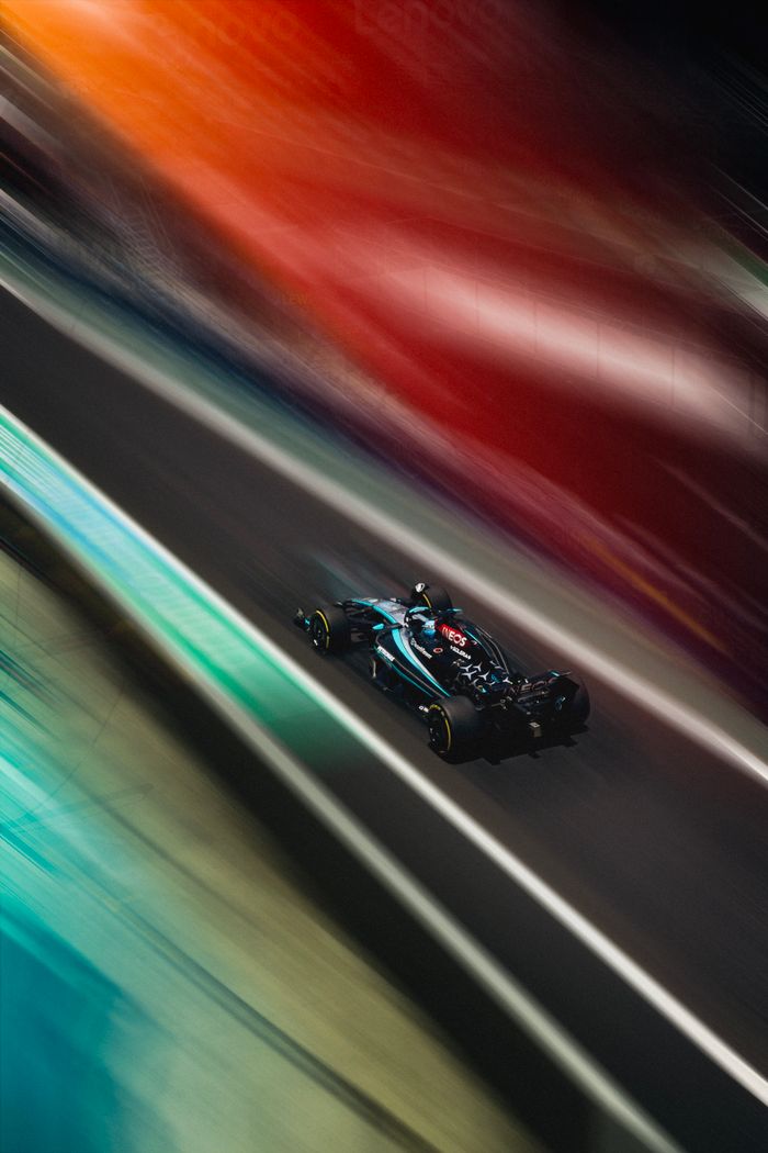services-02 Dynamic racing car shot with vibrant colors and motion blur on a track during the day.
